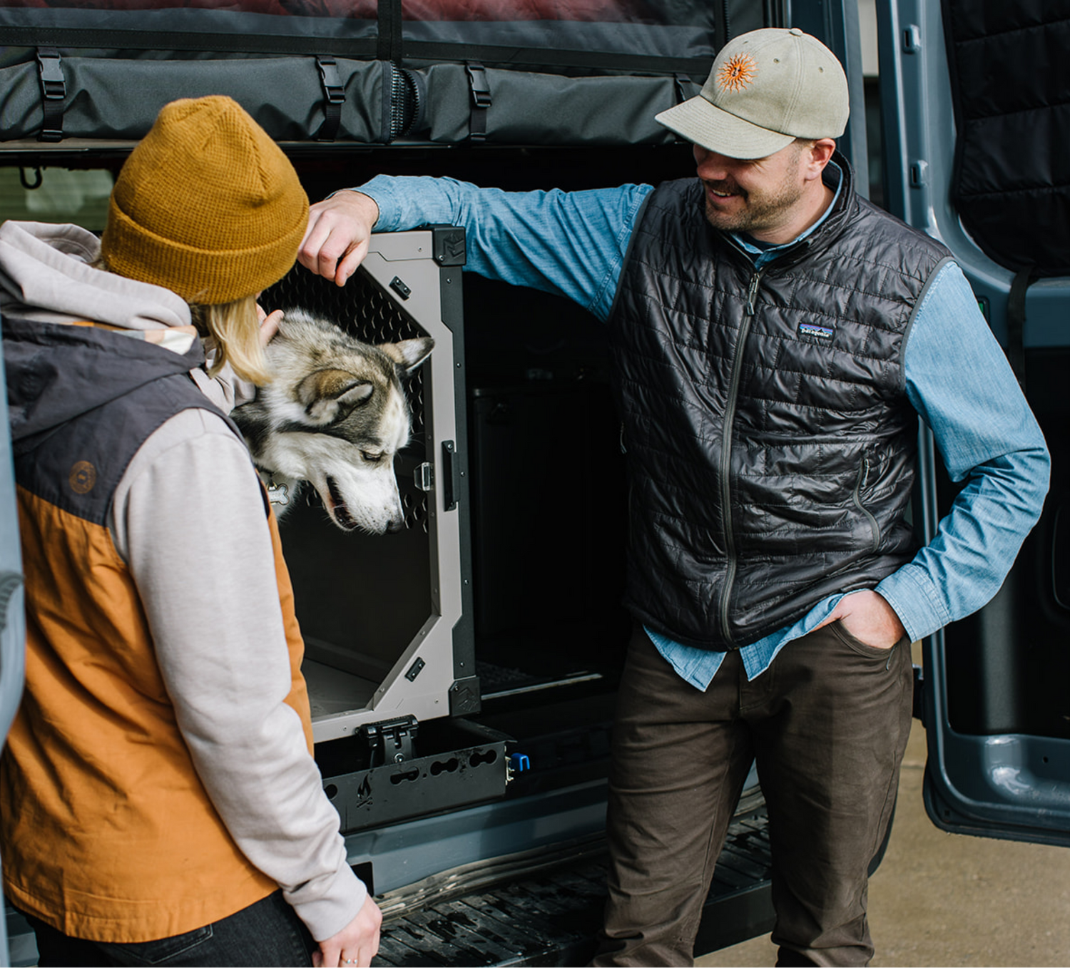 Two dog owners with stationary dog crate by Rock Creek Crates