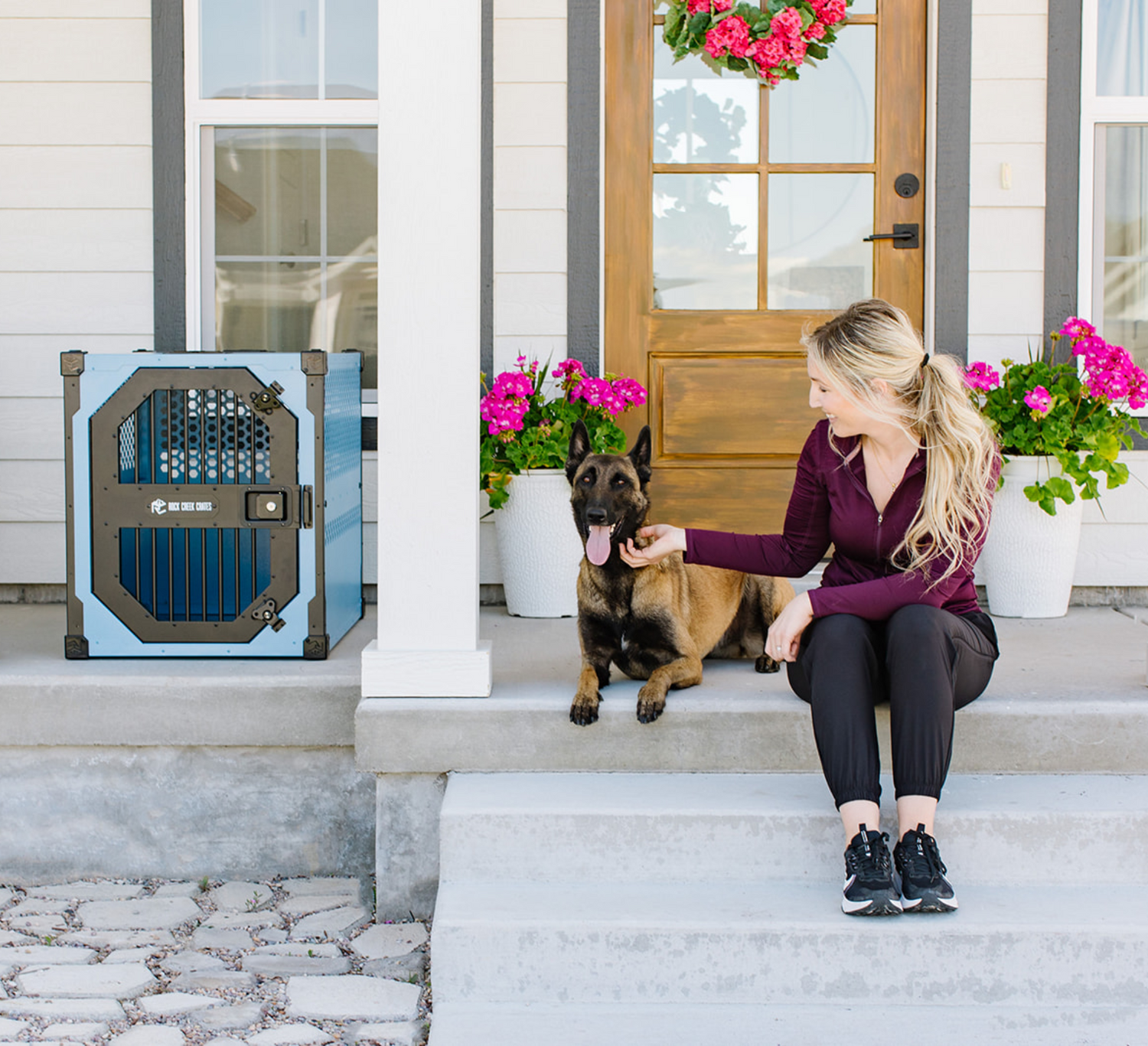 Blue collapsible dog crate by Rock Creek Crates on the porch of a home with a German Shepard and it's owner