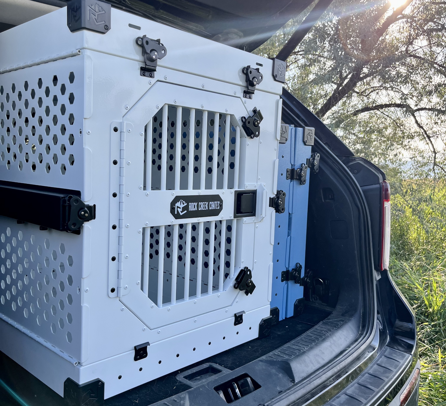 2 collapsible dog crates by Rock Creek Crates shown in the back of an SUV