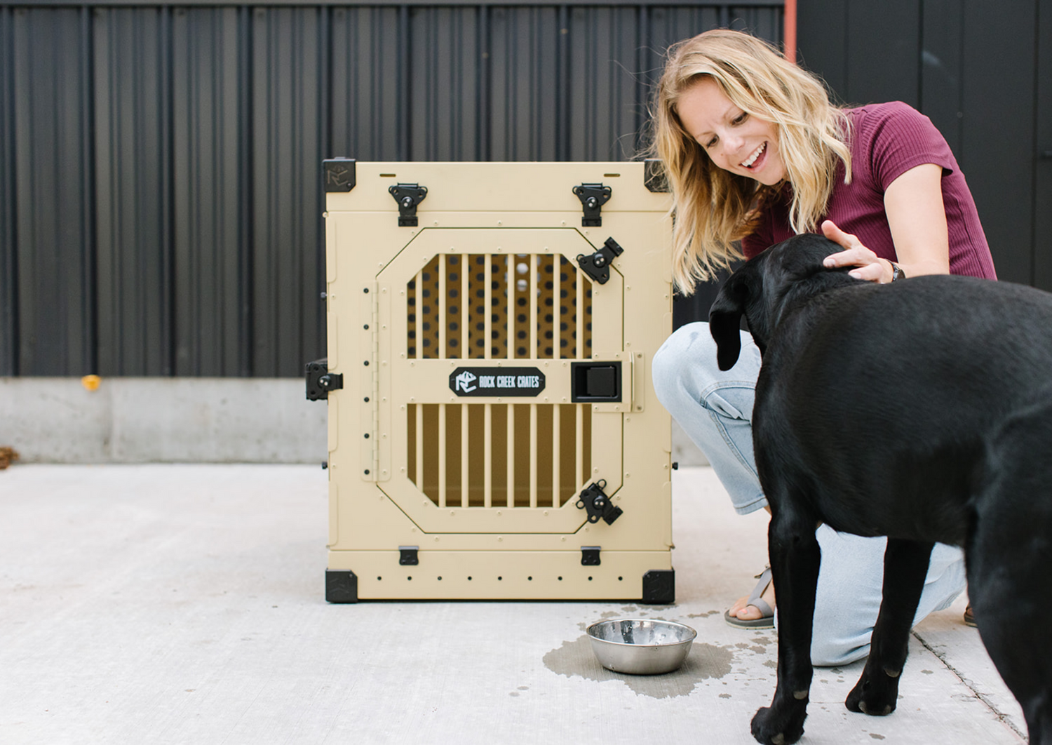 Rock Creek Crates collapsible crate featuring a black Labrador and owner