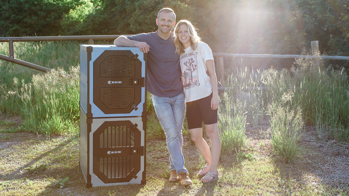 Rock Creek Crates business owners standing next to 2 stacked stationary crates 
