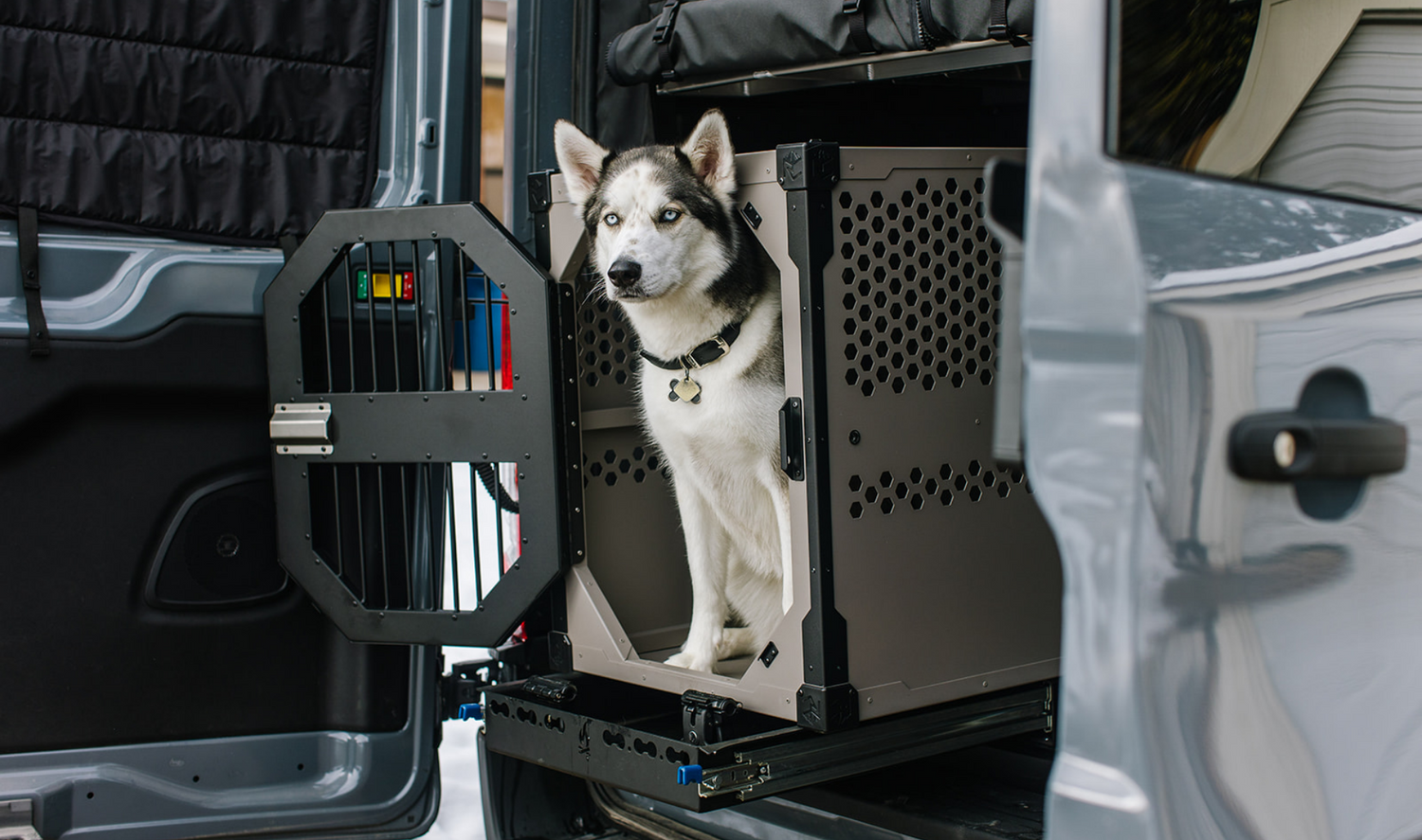 Grey stationary crate by Rock Creek Crates shown in a car with husky